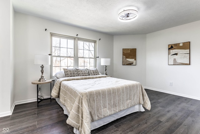 bedroom featuring dark hardwood / wood-style floors and a textured ceiling