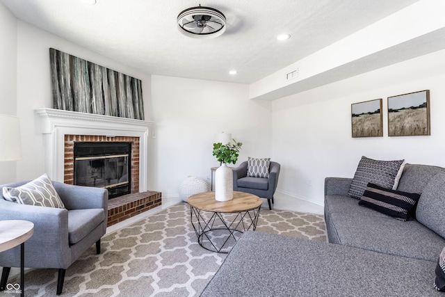 living room with a brick fireplace