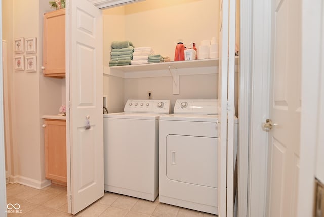 laundry room featuring light tile patterned flooring and separate washer and dryer