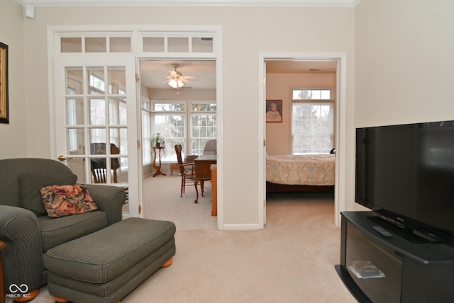 carpeted living room with ceiling fan