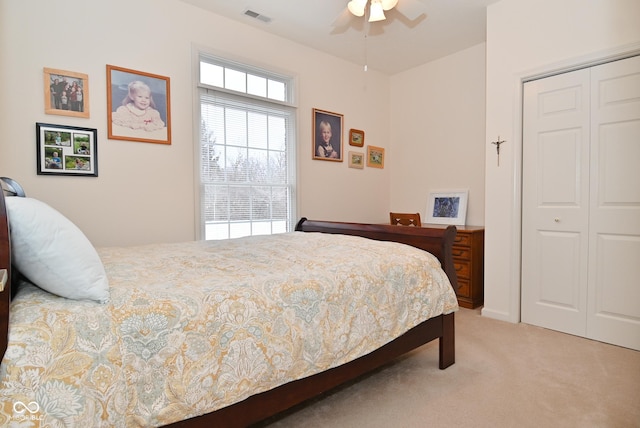 carpeted bedroom featuring a closet and ceiling fan