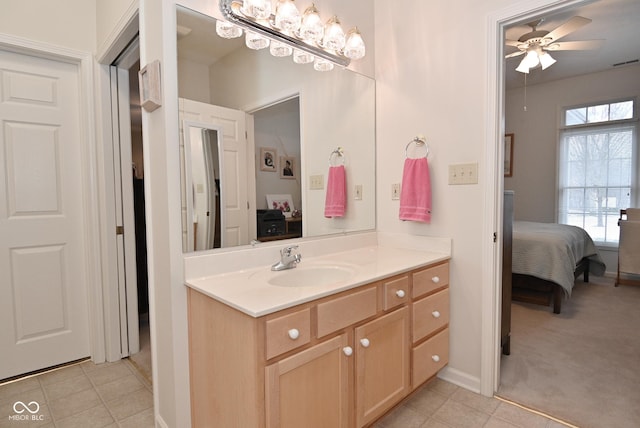 bathroom with tile patterned flooring, vanity, and ceiling fan