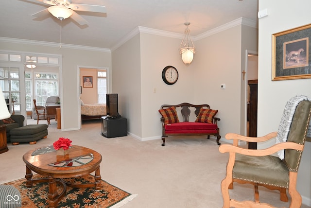 carpeted living room featuring ornamental molding and ceiling fan