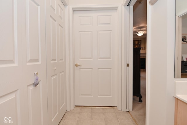 hall with light colored carpet