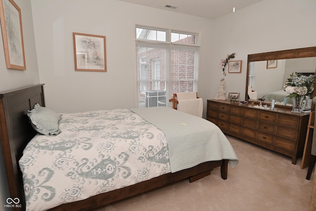 bedroom featuring light carpet