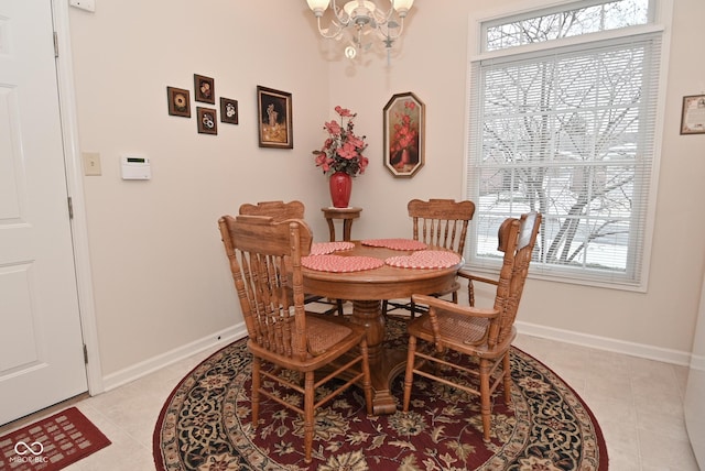 tiled dining room with a notable chandelier