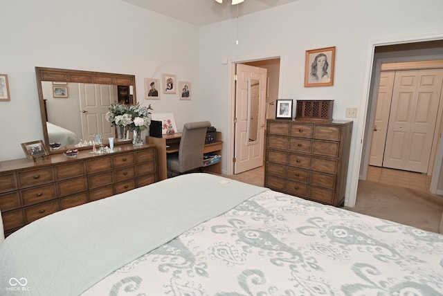 carpeted bedroom with ceiling fan and a closet