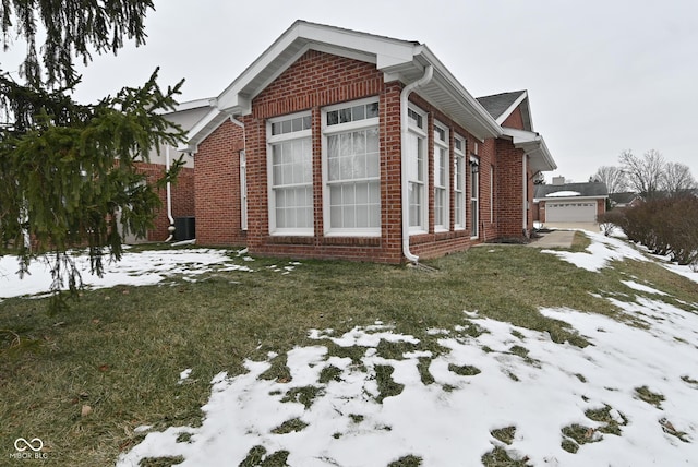 view of snowy exterior with a lawn