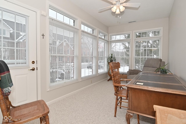 sunroom featuring ceiling fan