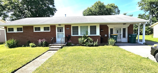 view of front of property with a front lawn and a carport