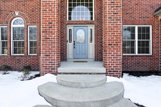 view of snow covered property entrance