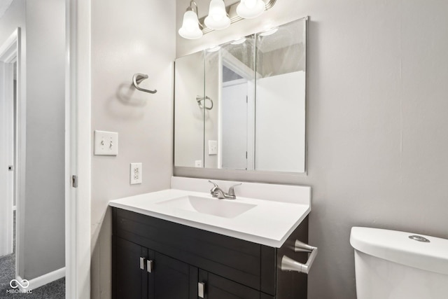 bathroom with toilet and vanity