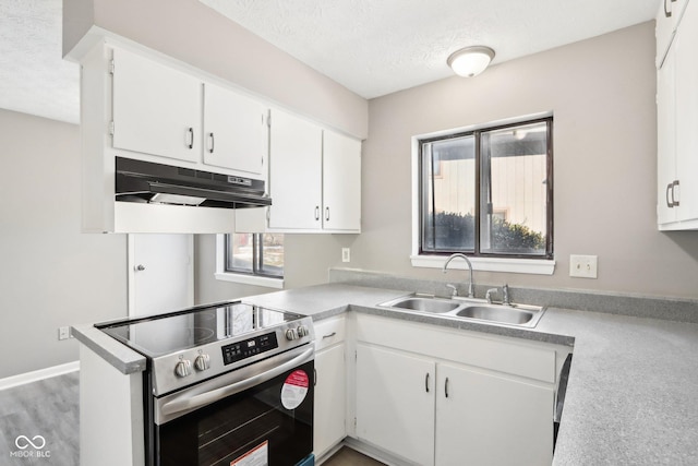 kitchen with stainless steel electric range oven, sink, and white cabinets