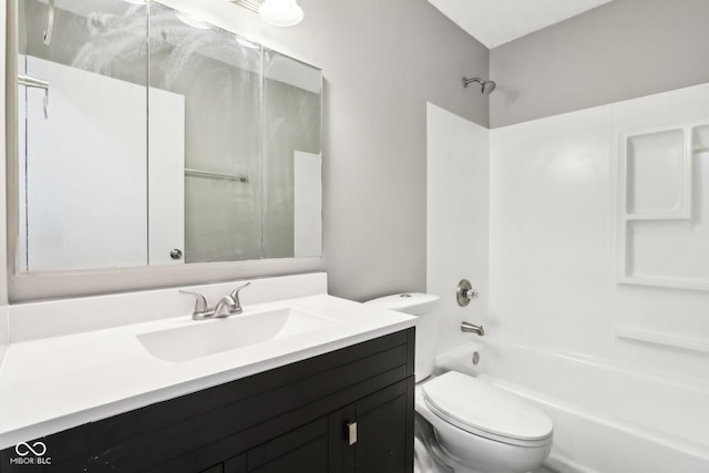 full bathroom featuring washtub / shower combination, vanity, and toilet