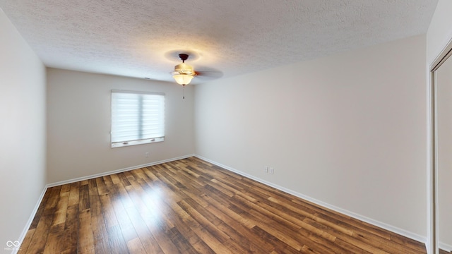 empty room featuring dark hardwood / wood-style floors, a textured ceiling, and ceiling fan