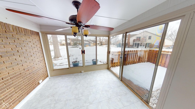 sunroom featuring ceiling fan