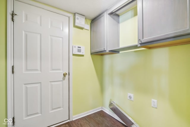 laundry room featuring cabinets, dark hardwood / wood-style flooring, and hookup for an electric dryer