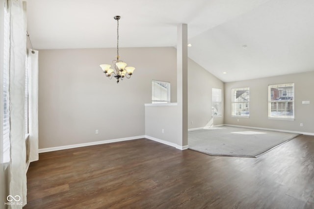 unfurnished room with dark wood-type flooring, a notable chandelier, and lofted ceiling