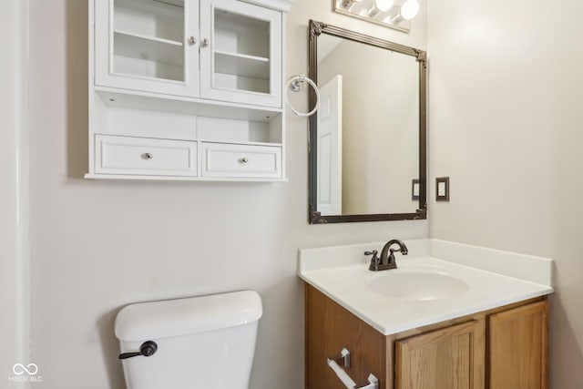 bathroom featuring toilet and vanity