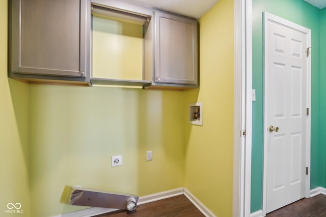 clothes washing area with cabinets, hookup for a washing machine, dark hardwood / wood-style floors, and hookup for an electric dryer