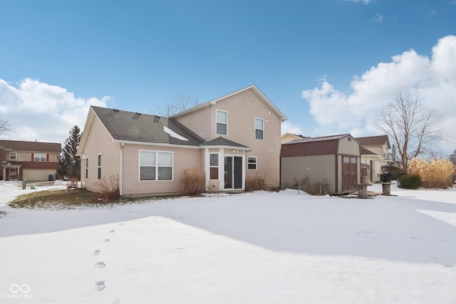 view of snow covered back of property