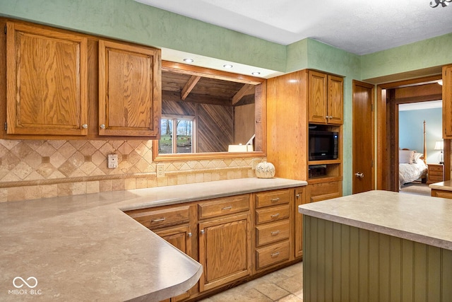 kitchen with backsplash and black microwave