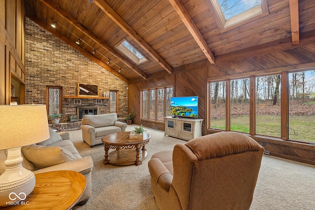 living room with wood ceiling, beam ceiling, a skylight, high vaulted ceiling, and wood walls