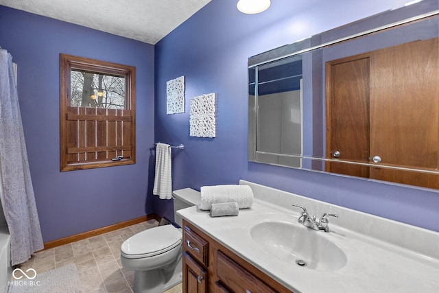 full bathroom with vanity, toilet, shower / tub combo, and a textured ceiling