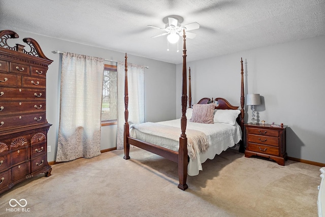 carpeted bedroom with ceiling fan and a textured ceiling