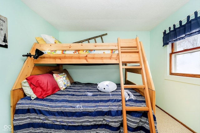 bedroom with carpet floors and baseboards