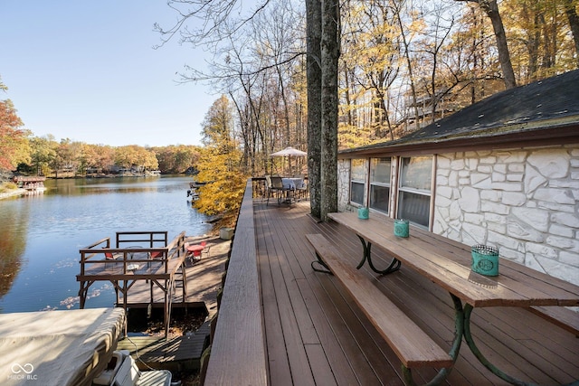 wooden terrace featuring a water view and a dock