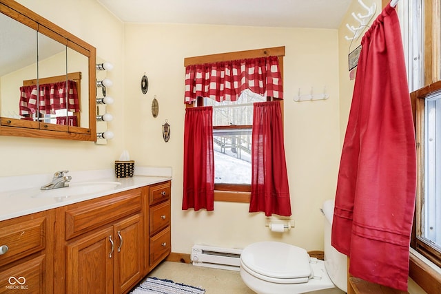 bathroom featuring toilet, baseboard heating, and vanity