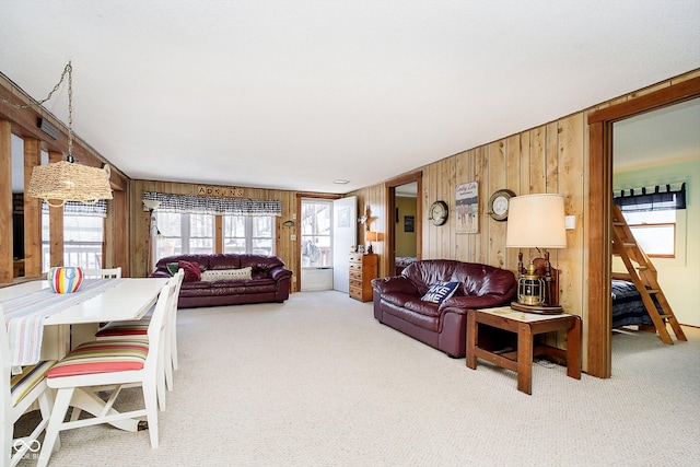 living room with carpet floors and wood walls