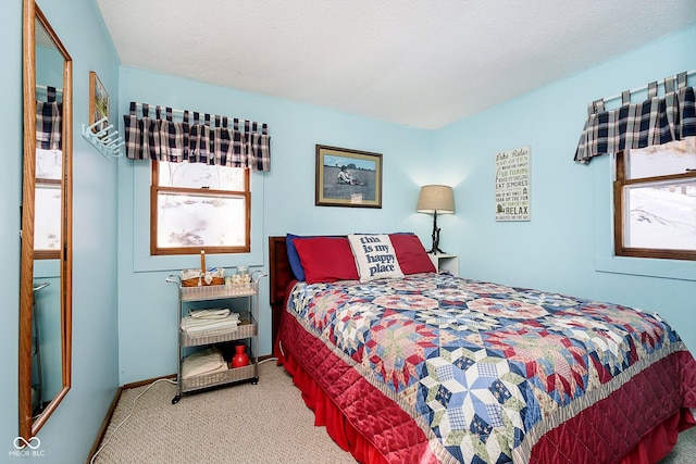 bedroom featuring carpet floors and a textured ceiling