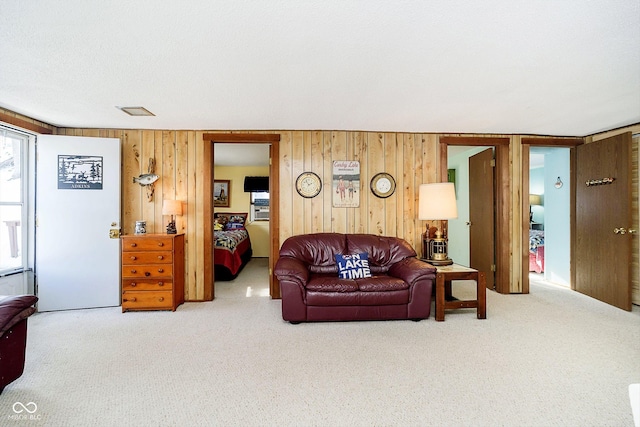 living room with wooden walls and carpet flooring