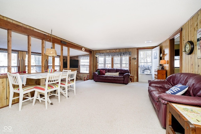 living room featuring wood walls and carpet flooring