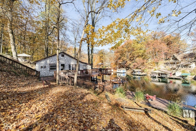 view of yard with a water view and a dock