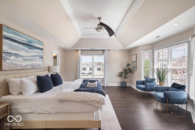 bedroom with crown molding, ceiling fan, baseboards, dark wood-style floors, and a raised ceiling