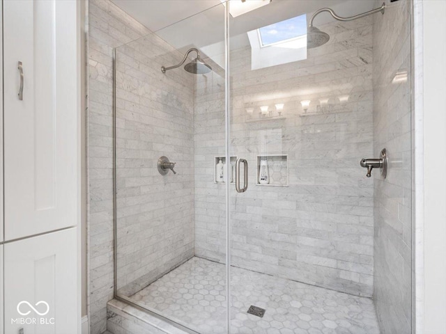 bathroom featuring a shower stall and a skylight