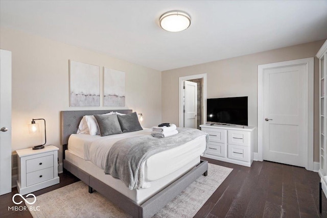 bedroom featuring dark wood-style flooring