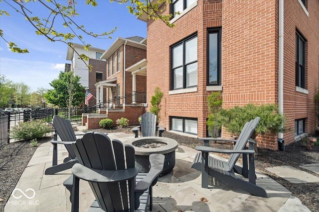 view of patio / terrace with a fire pit and fence