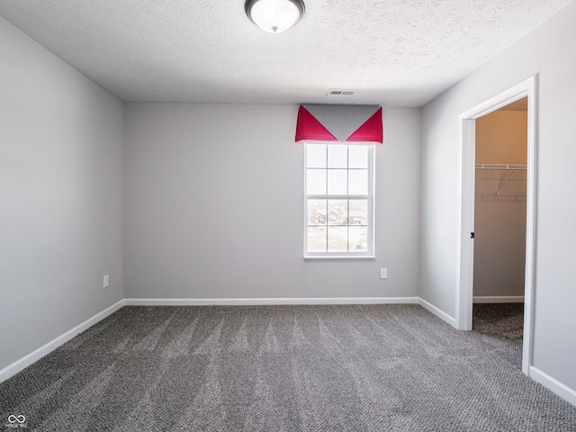 carpeted spare room with a textured ceiling