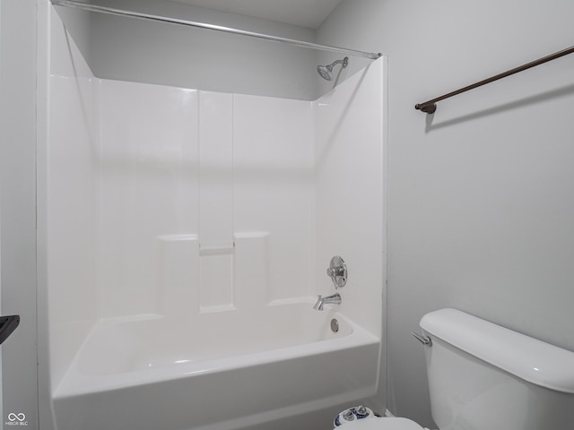 bathroom featuring shower / washtub combination and toilet