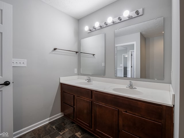 bathroom with vanity and a textured ceiling