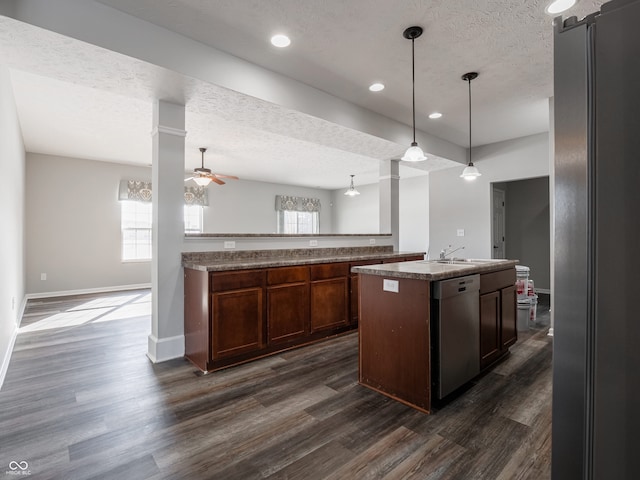 kitchen featuring decorative light fixtures, dishwasher, black fridge, dark wood-type flooring, and a textured ceiling