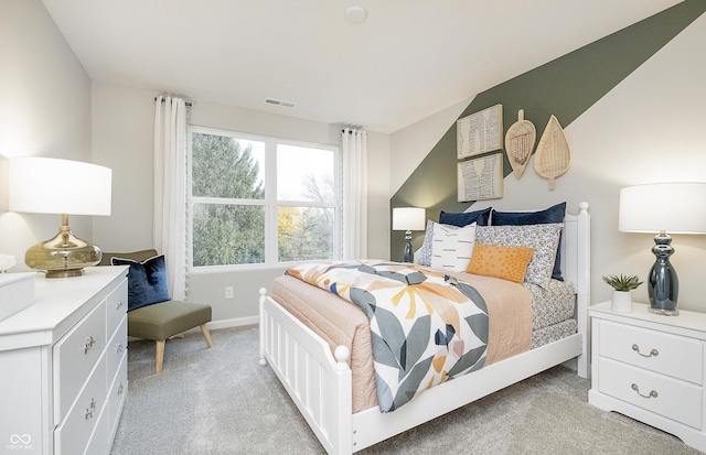 bedroom with light carpet, visible vents, and baseboards