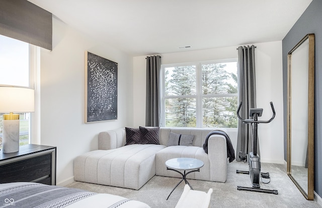 bedroom with visible vents, light carpet, and baseboards