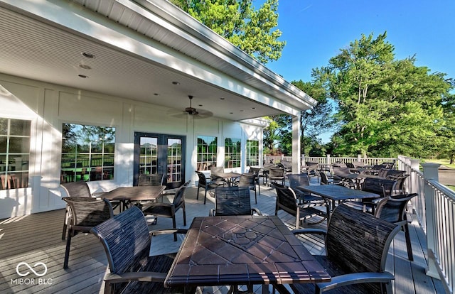 wooden terrace featuring a ceiling fan and outdoor dining area