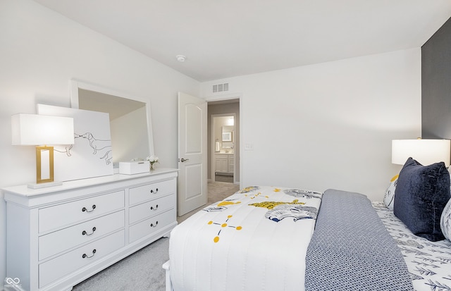 bedroom with visible vents and light colored carpet