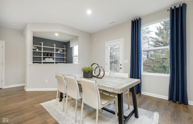 dining room featuring visible vents, baseboards, and wood finished floors